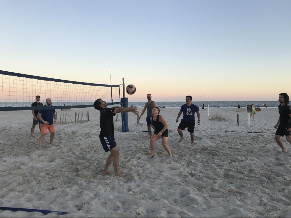 A beach volleyball game at the Fall 2018 company retreat to Hilton Head, SC