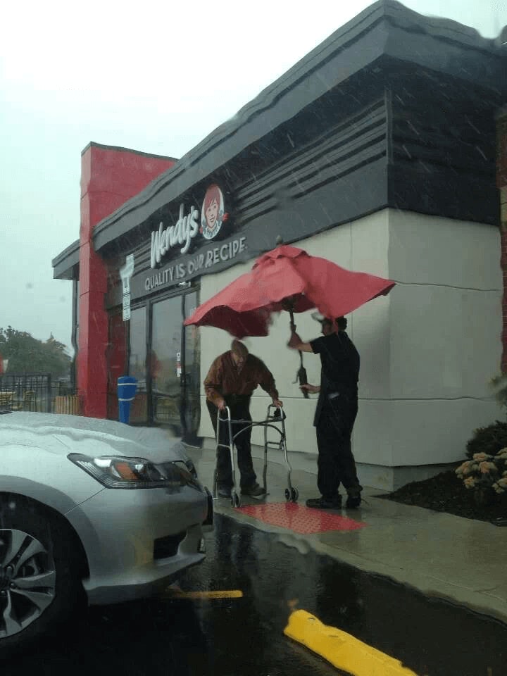 Wendys Employee helps man to his car