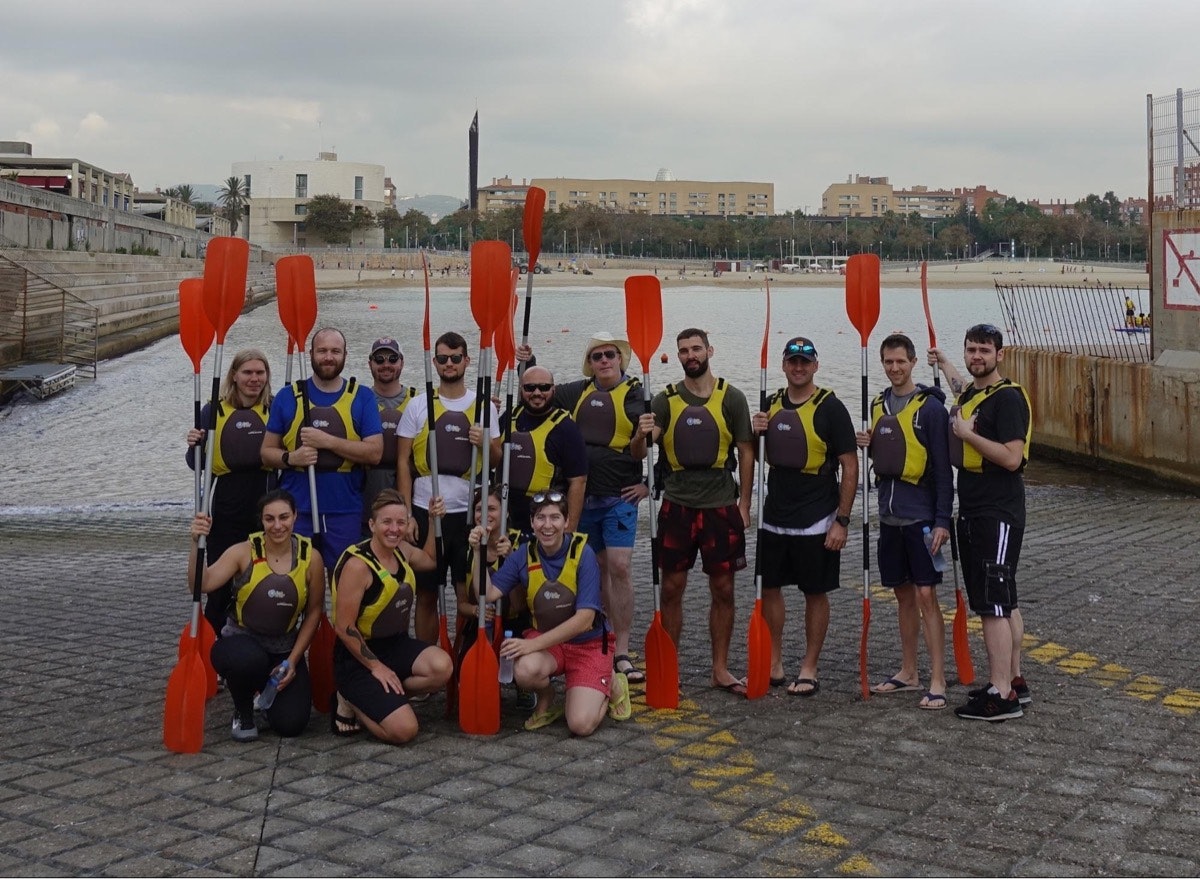 A crew of sea kayakers with their paddles during Help Scout’s 2017 retreat to Barcelona, Spain